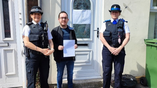 Wirral anti-social behaviour officer and police officers outside the address that has been subject to a closure order