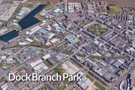 Aerial image of part of Birkenhead showing the former rail line of planned Dock Branch Park stretching from left to right