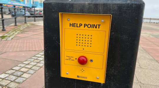 close up of yellow communication point with the words "Help Point" and red button which is used to call the emergency control room
