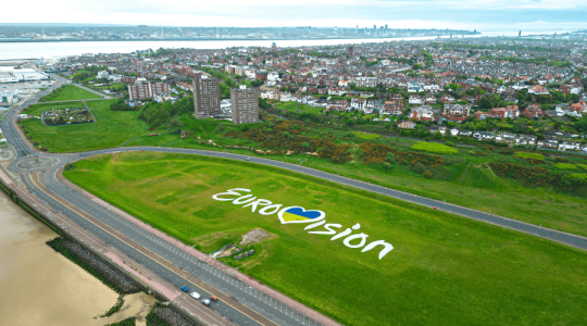Aerial shot of New Brighton dips - which is an open green space - with the Eurovision logo on the grass