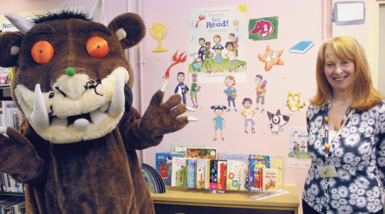 Wirral librarian standing next to a person in a Gruffalo costume