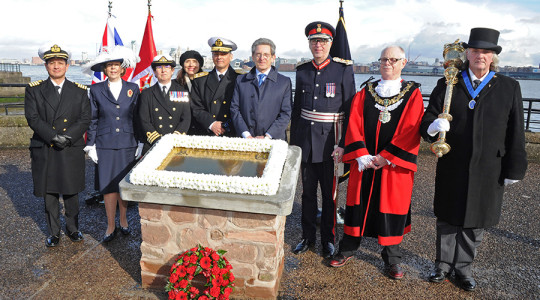 Picture of the Mayor and his guests at the memorial plaque to Admiral Grau