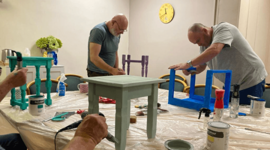 People painting furniture
