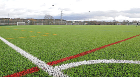 Close up shot of football pitch with lines in shot