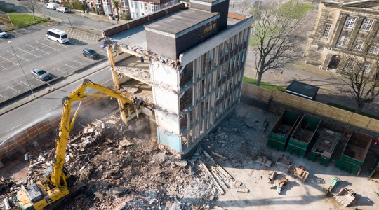 aerial view of Wallasey town hall South Annexe being demolished, showing around half the building removed
