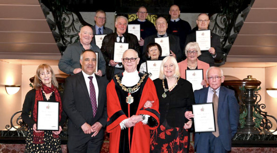 Photo of the Mayor, Mayoress and Council Chief Executive with the Wirral Award recipients on a staircase at Birkenhead town hall