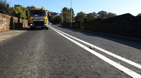 A road laid with Hot Rolled Asphalt has new lines painted on