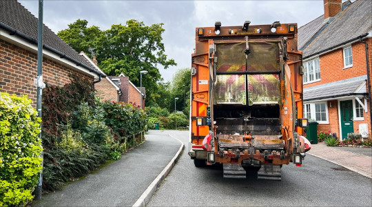 A bin collection lorry in a residential street