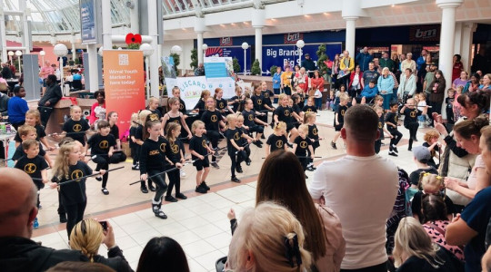 dance troupe of children performing in the cherry tree centre, liscard while parents watch on