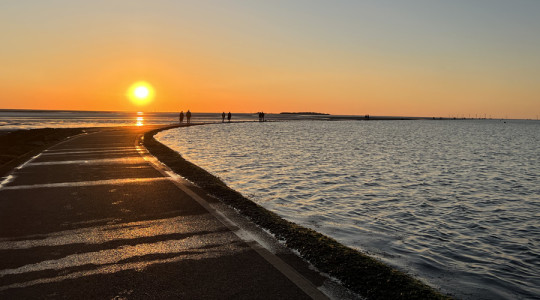 West Kirby Marine Lake walking path lit up by the setting sun.