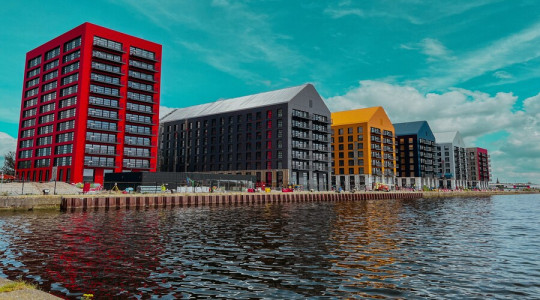 buildings which make up Millers Quay, with the dock water in the foreground