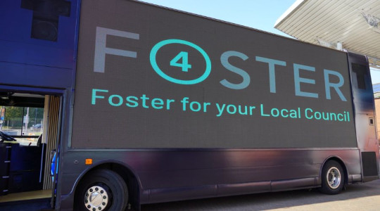 Media bus displaying the Foster4 logo on a large screen.