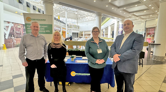 Three staff members from energy projects plus stand next to paul stuart council leader