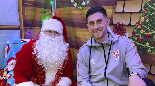 Father christmas (left) sits next to tranmere football club goalkeeper