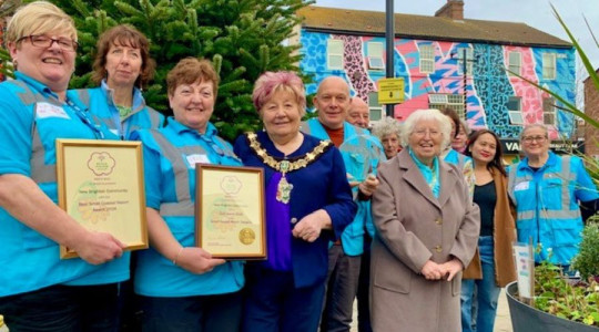 Photo of the Mayor and Mayoress with In Bloom volunteers holding their certificates and a glass award