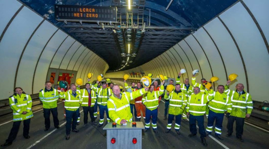 Cllr Steve Foulkes officially switches on the new LED lighting system in the Queensway tunnel alongside members of the project team who made it happen