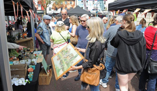 Customers in a busy street browse a previous Youth Market event 