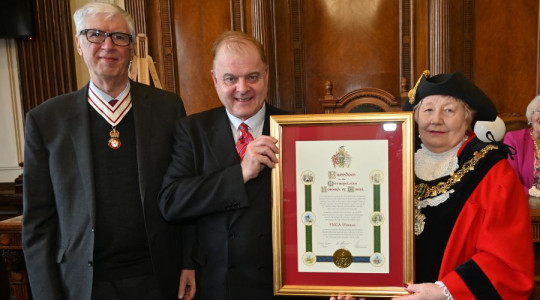 L-R: The Lord-Lieutenant of Merseyside  joins the CEX of YMCA Wirral as he receives a commemorative scroll from the Mayor