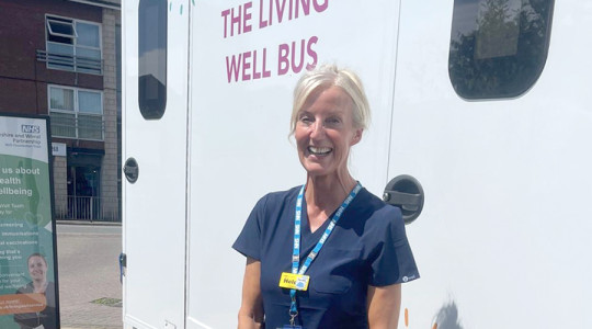 picture of clinical lead, heledd, in front of the bus