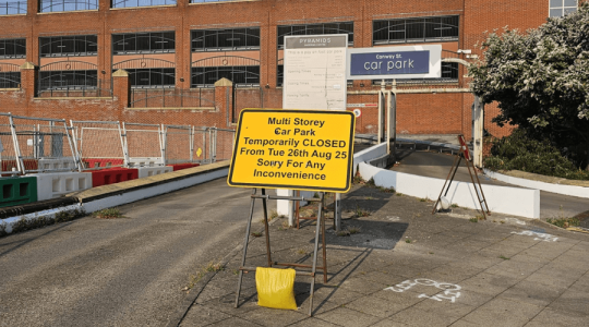 Yellow highway sign at the entrance of the Grange multi-story car park on Conway Street, Birkenhead that informs people that the car park is closed from Tuesday 26 August