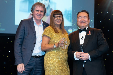 A picture of Mayor Steve Rotheram, Judge's Inspiration winner Karen Gallagher and host of the awards ceremony stood on stage at last year's event, with Karen holding her award