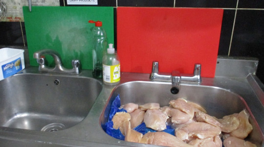 Evidence photo showing raw chicken in sink of Wallasey pizza takeaway