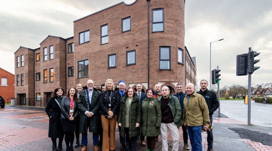 Group photo outside one of the new completed apartment  blocks in New Ferry