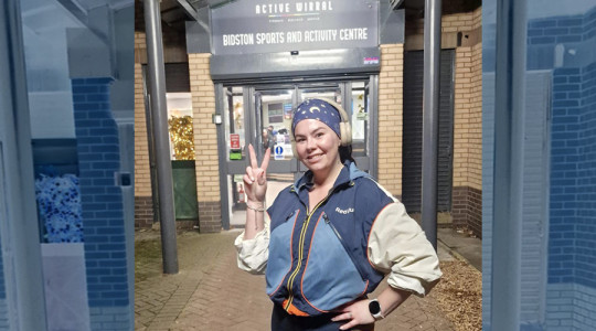 Chelsea, a member of Girls Run The Streets is standing outside Bidston Sports and Activity Centre