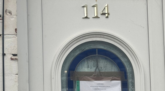 Photograph of the front door of a house that is the subject of the Closure Order