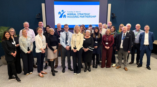 A group of people gathered for the launch of the Wirral Strategic Housing Partnership