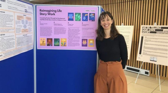 Woman standing beside display that shows a project around Life Story cards