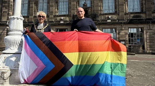 Photo of the Mayor of Wirral, Councillor Mary Jordan, and the Founder of Wirral Pride, Jamie Lee Carter, raising the Rainbow Flag at Wallasey Town Hall