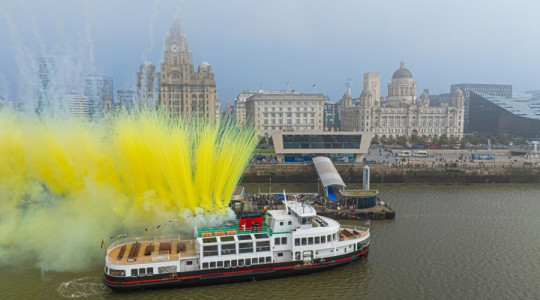 new mersey ferry in front of Liverpool waterfront's three graces