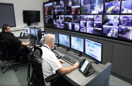 Two CCTV operators working in front of multiple screens showing live CCTV from around the borough