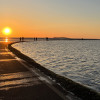 West Kirby Marine Lake walking path lit up by the setting sun.
