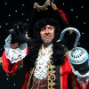 PPhoto of Tom Lister in a Captain Hook costume in front of a star cloth