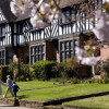 A family walk past historic buildings in Port Sunlight