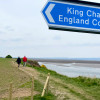Two people with their dog walking along King Charles III Coastal Path, Thurstaston, Wirral