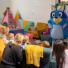 Children with parents, carers and grandparents listening to story time from Bluey