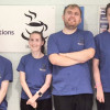 Four young people wearing purple bestbites tshirts smiling