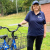 erson with an accessible adult tricycle from 'Wheels for All', promoting inclusive cycling.