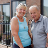 An older couple outside their new home in New Ferry