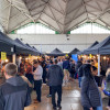 Lots of people shown browsing stalls at a jobs fair in Birkenhead Market