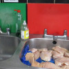 Evidence photo showing raw chicken in sink of Wallasey pizza takeaway