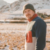 Scott in foreground wearing winter wear with mountains in background covered in snow