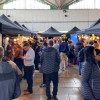 Lots of people shown browsing stalls at a jobs fair in Birkenhead Market
