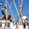 people doing circus skills with bamboo canes