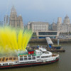 new mersey ferry in front of Liverpool waterfront's three graces