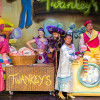 The cast of Aladdin grouped together on stage at the Floral Pavilion
