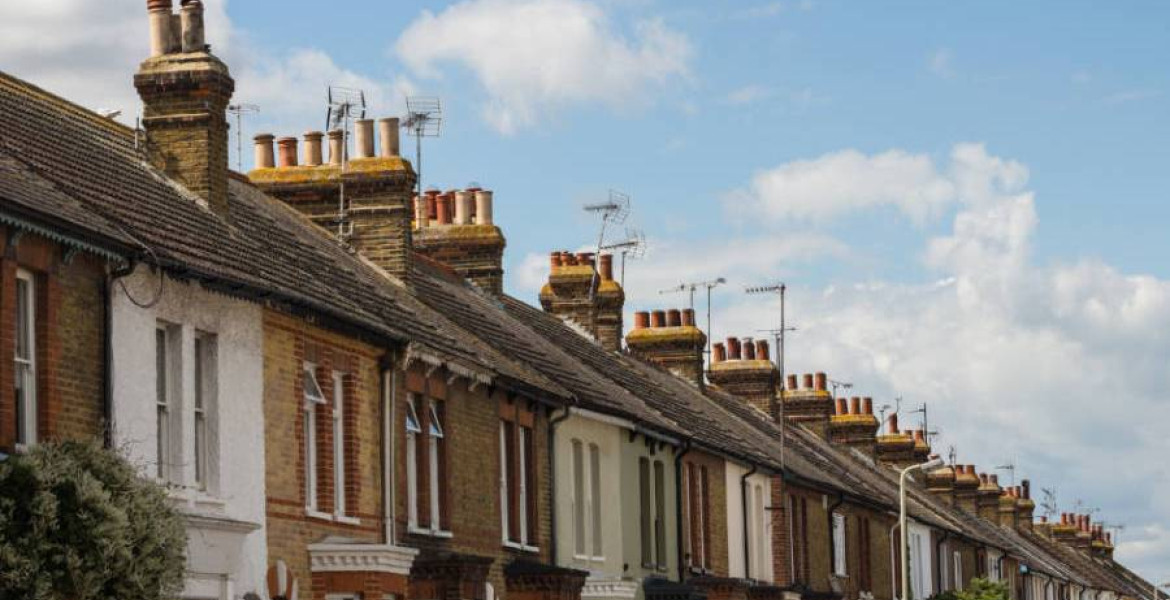 A stock images showing a row of terraced houses set against a blue and cloudy sky